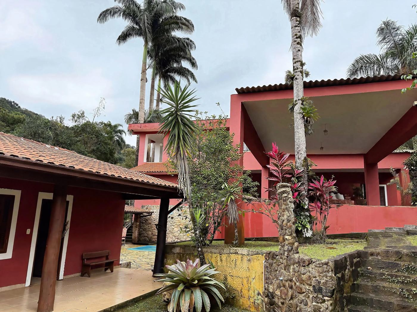 Casa principal e jardim com bromélias